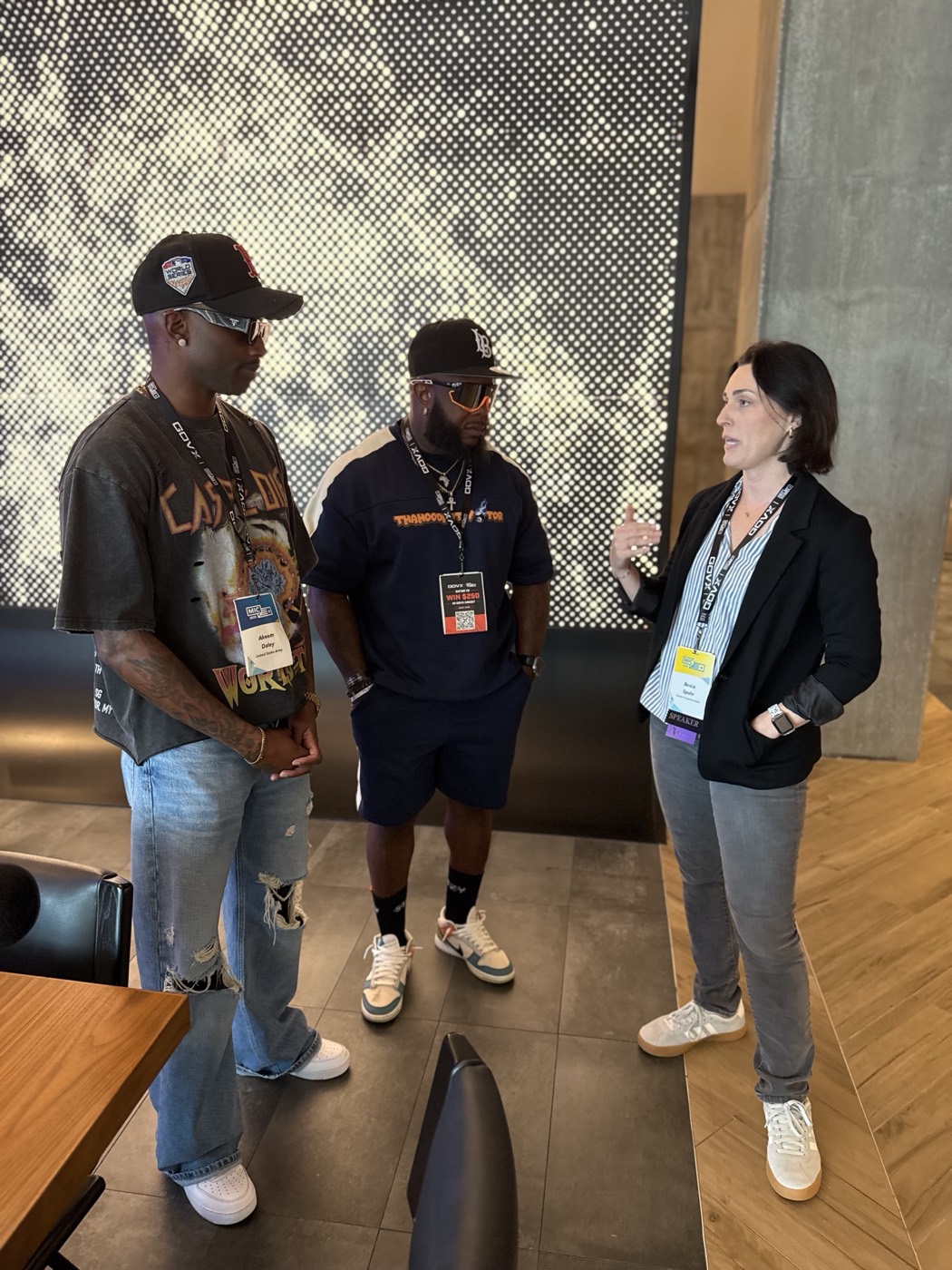 Two creators in conversation with a speaker between sessions