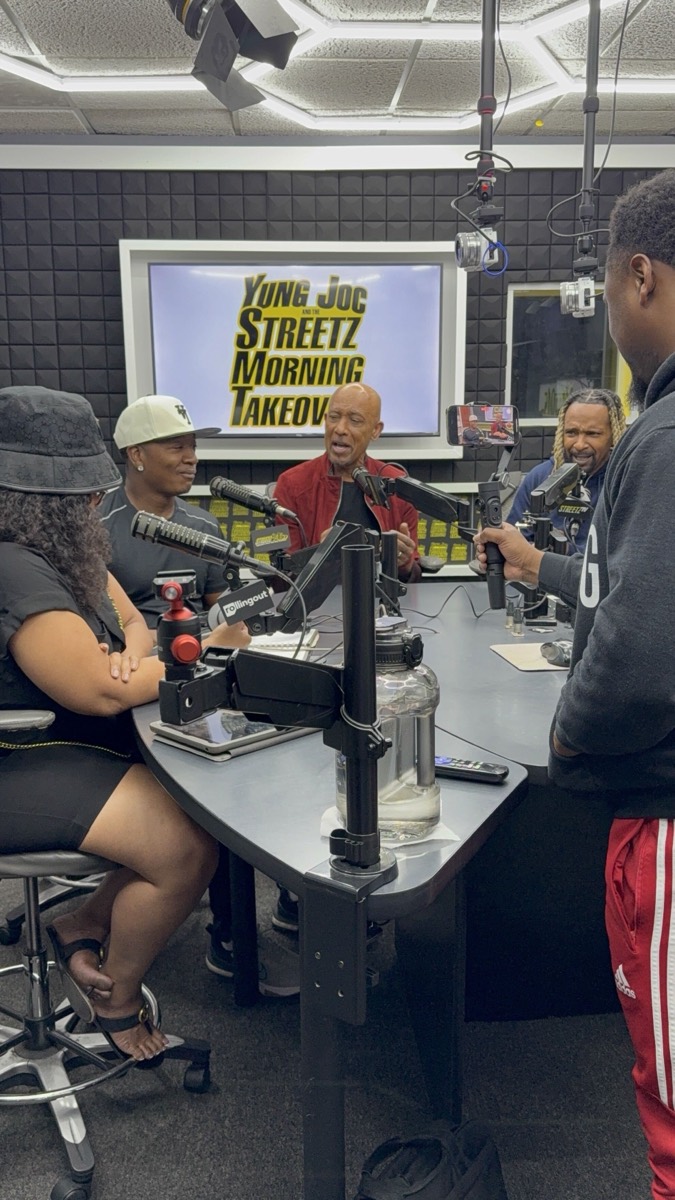A morning-show studio with hosts and guests around a microphone desk